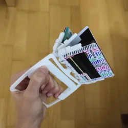 Springloaded book-like wallet with a trigger
