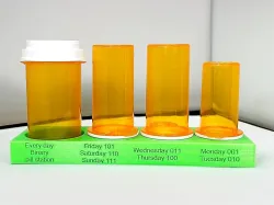 A Pill bottle stand for four Walgreens bottles - one large, two medium and one small