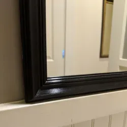 Stick-on frame for bathroom mirror