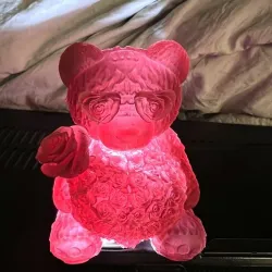Teddy bear holding heart and a rose