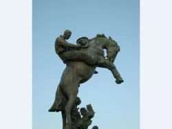 bucking bronco and a steadfast cowboy in wool chaps
