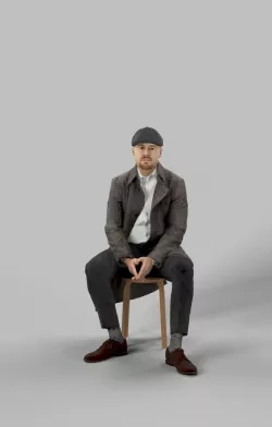 Mark A Sitting Man In A Winter Coat And A Newsboy Tweed Cap Low-poly  3D model