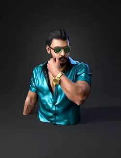 adult male in turquoise shirt with gold accessories and visible tattoo