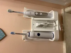 Sonicare Stand with Waterpik Attachments and Toothpaste Hanger over GFCI