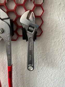 Holder for small adjustable wrench for honeycomb storage wall system (HSW)
