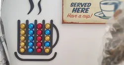 Wall mounted, mug shaped Nespresso capsule dispenser