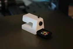 Miniature sewing machine with drawer for needles