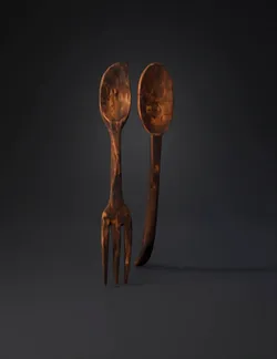 two rustic wooden spoon and fork with worn patina
