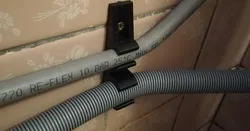 Enhanced washing machine hose holder