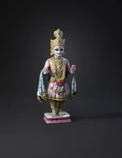 ornate gilded deity statue with pink and blue robes jeweled headdress
