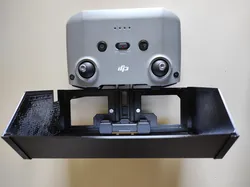 DJI Mini 2 sunshade fixed to the pipes of a DJI controller