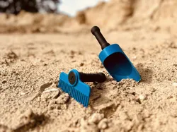 Sandy beach rake and shovel.