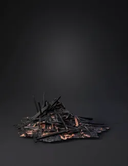 rubble pile composed of charred wood and brick debris dark gray and b