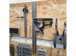 Wall bracket for adjustable carpenters square