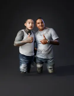 Two tattooed men in casual outfits posing side by side with thumbs up