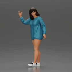 Sexy girl in a long shirt and shoes walks by waving hello to someone