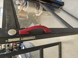Command strip mounted bay door handle