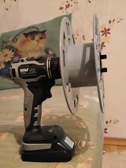 Adapter for winding the filament onto the D200 coil with a screwdriver.