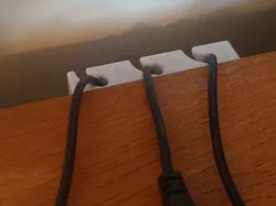 Cable holder behind table