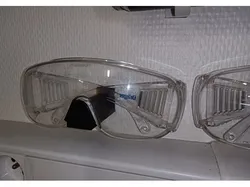 Safety glasses holder for wall
