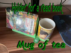 Holder for a read book and a mug of tea