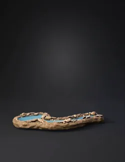 rocky creek diorama with blue water and scattered pebbles