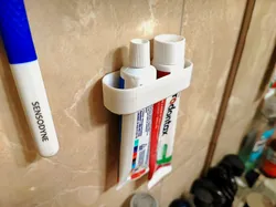 Toothpaste wall holder