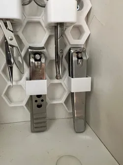 Honeycomb nail clipper holder