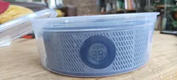Curved desiccant container for filament spool with funnel