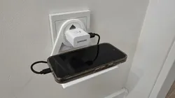 Mobile phone holder plugged into a European socket