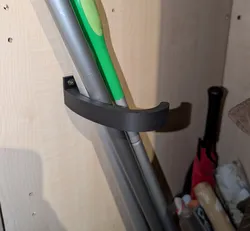 Broom holder for wardrobe