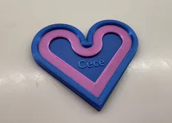A heart shaped cookie with "Cece" on it