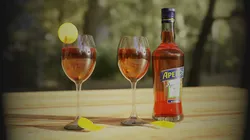 Aperol bottle of wine and two glasses on wooden table Free 3D model