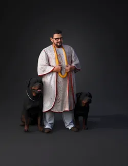 man in white ceremonial robe with red script two rottweiler dogs besi