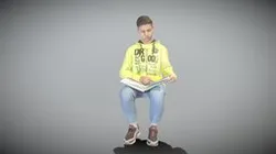 Young man sitting in chair reading book 226
