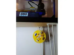 Filament holder hanging on filament entry through Ikea desk