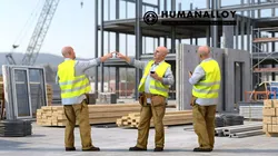 Senior Caucasian man calling on smartphone in construction 3D model