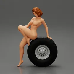 Sexy naked girl sitting on a truck tyre