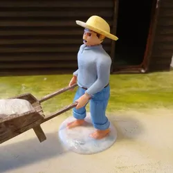 A 7cm saunier santon pushing a wheelbarrow of salt